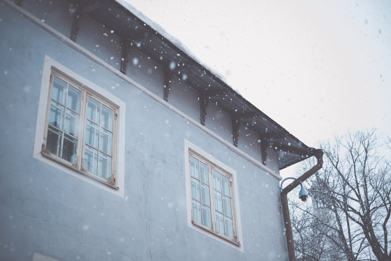 Home A low-angle view of a building during a snowy winter day in Tallinn, Estonia.