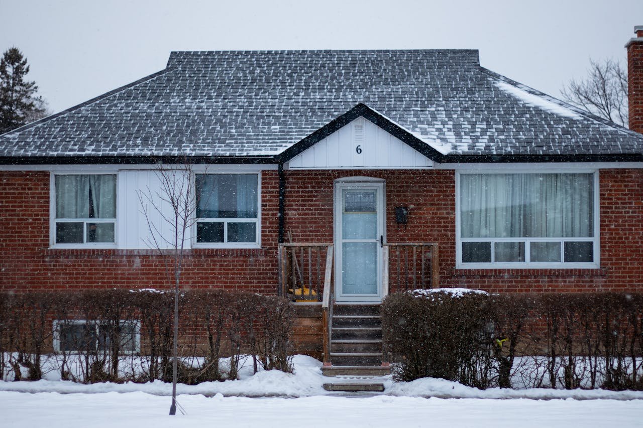 Services A suburban brick house in Toronto covered with snow on a winter day.